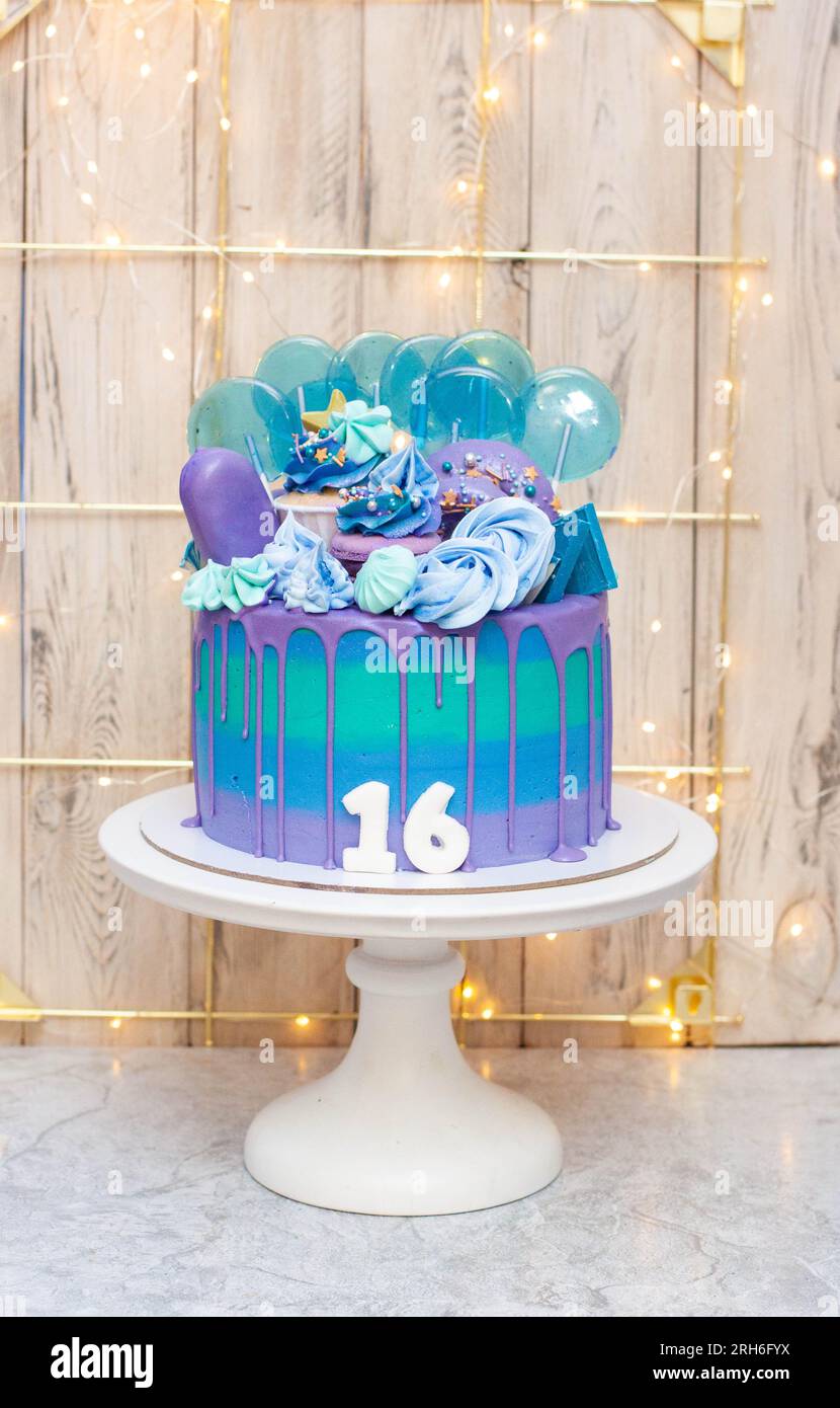 Gâteau d'anniversaire bleu, violet et vert pour un adolescent de seize ans. Sweet seize célébration Banque D'Images