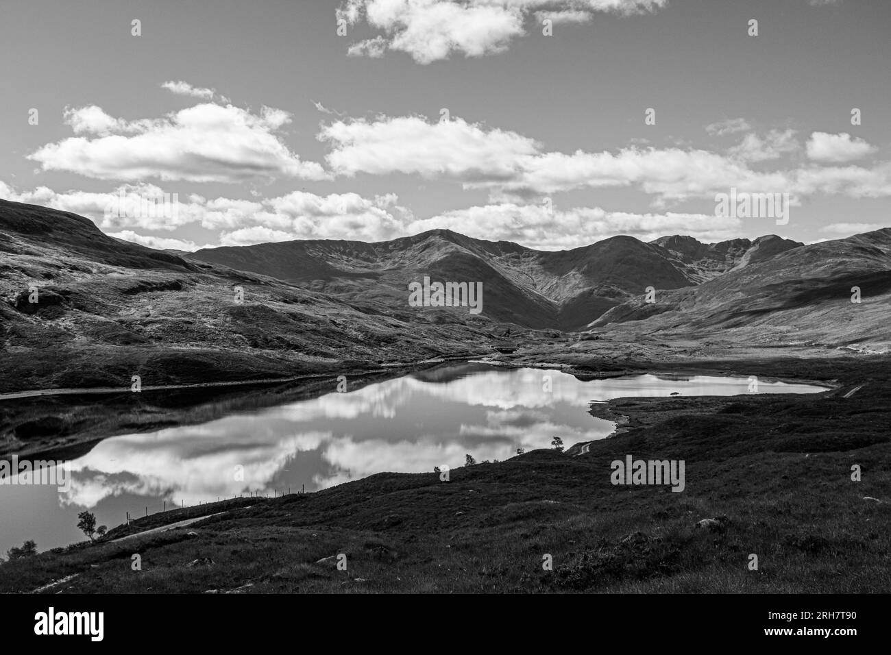 Vue sur le loch et les montagnes dans les hautes terres de Scotlands en noir et blanc Banque D'Images
