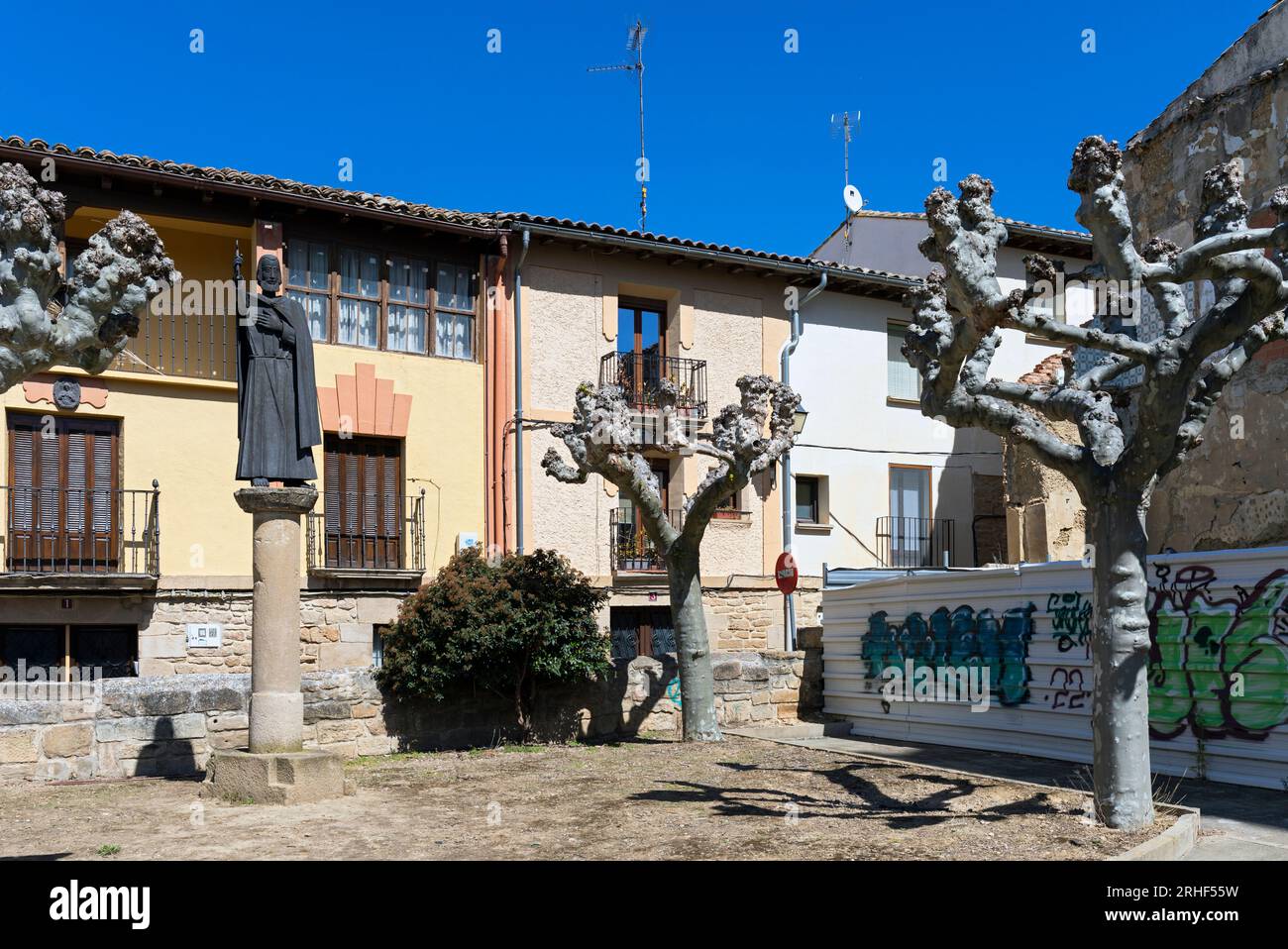 Europe, Espagne, Navarre, Olite, Plaza del Fosal avec des arbres rongeurs et une statue religieuse Banque D'Images