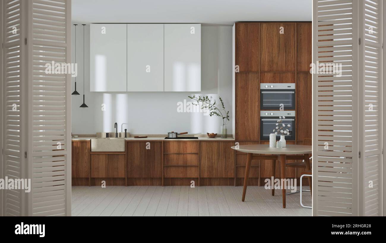 Porte pliante blanche s'ouvrant sur une cuisine en bois japandi et une table à manger, décoration intérieure minimaliste, concept architecte designer Banque D'Images