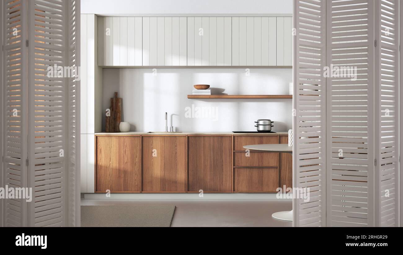 Porte pliante blanche s'ouvrant sur une cuisine en bois japandi et une table à manger, décoration intérieure minimaliste, concept architecte designer Banque D'Images