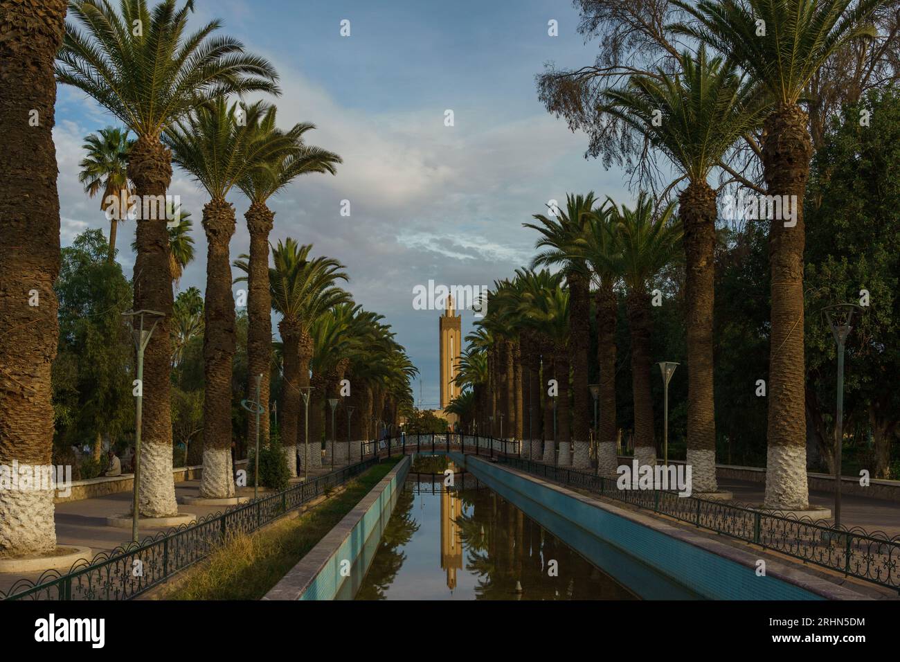 Afrique du Nord. Maroc. Taroudant. Canaux d'irrigation (seguias), bordés de palmiers, en arrière-plan le minaret de la mosquée Banque D'Images