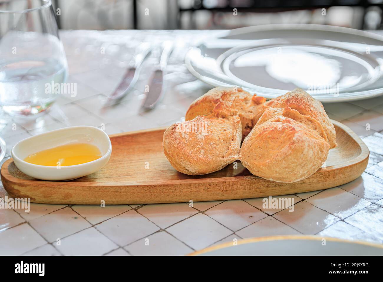 Pain rustique frais et huile d'olive à une table en plein air dans un restaurant dans la ville médiévale de Saint Paul de Vence, Côte d'Azur, Sud de la France Banque D'Images