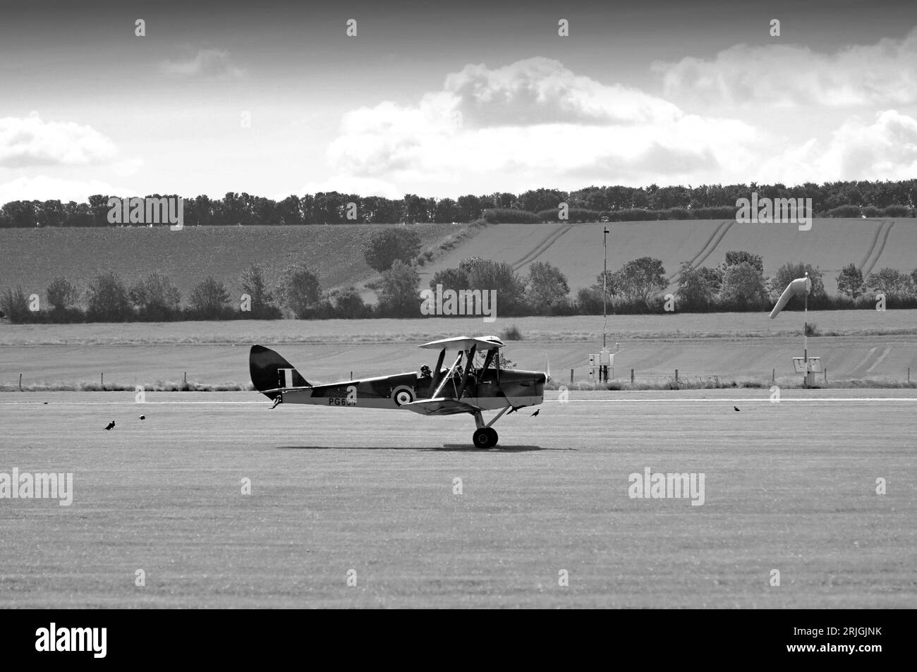 La Classic Wings camouflait l'entraîneur DH Tiger Moth de la Seconde Guerre mondiale en décollant avec une chaussette molle sous un beau soleil à l'Imperial War Museum et Airfiel Banque D'Images