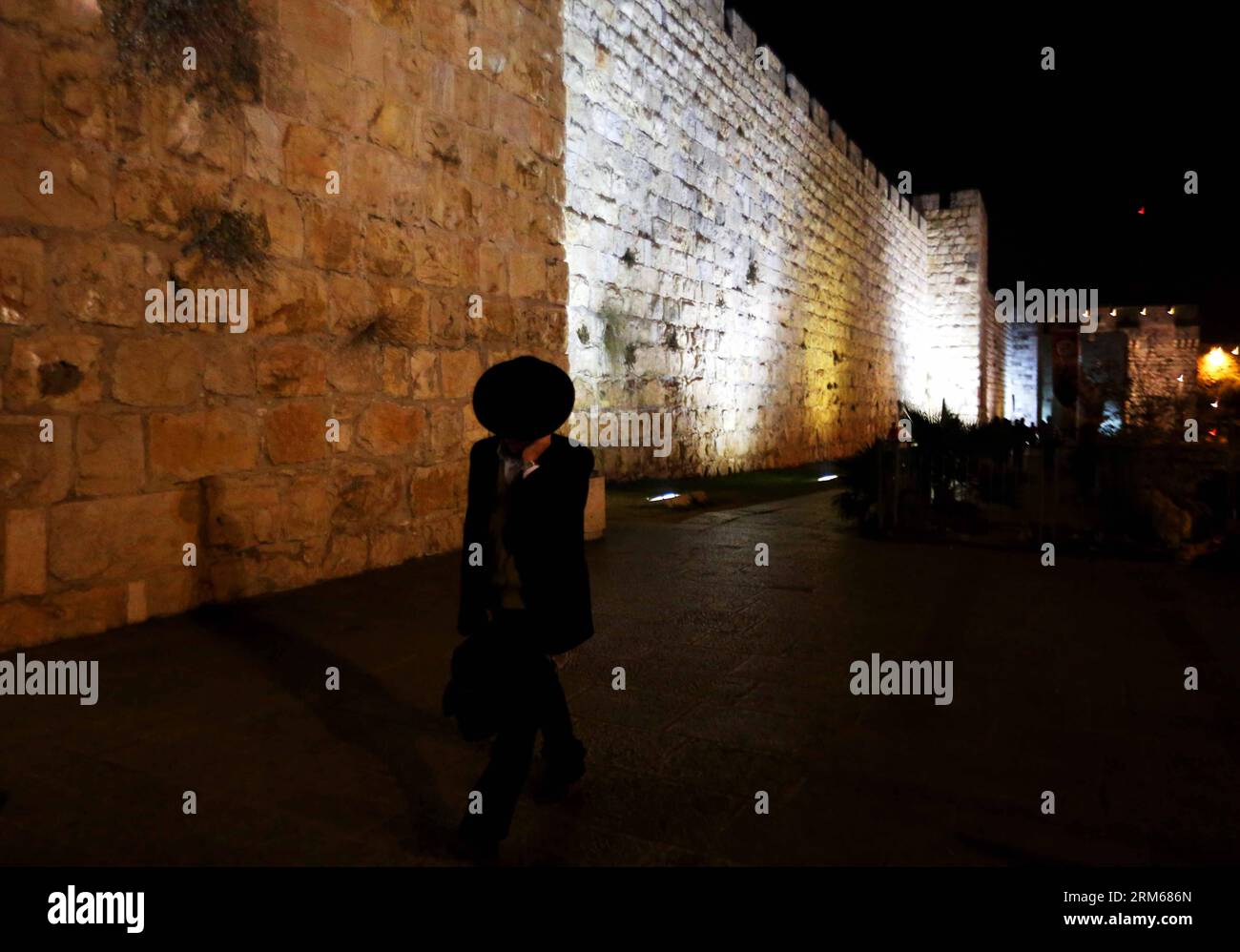 JÉRUSALEM, 17 déc. 2013 (Xinhua) -- Un homme marche le long du mur Ouest dans la vieille ville de Jérusalem le 17 novembre 2013. Jérusalem, l'une des plus anciennes villes du monde, est sainte pour les trois grandes religions abrahamiques - le judaïsme, le christianisme et l'islam. Israéliens et Palestiniens revendiquent Jérusalem comme capitale, Israël y maintenant ses principales institutions gouvernementales. La vieille ville de Jérusalem a été traditionnellement divisée en quatre quartiers, à savoir les quartiers arménien, chrétien, juif et musulman. Il est devenu un site du patrimoine mondial en 1981, et est sur la liste du patrimoine mondial en péril. Banque D'Images