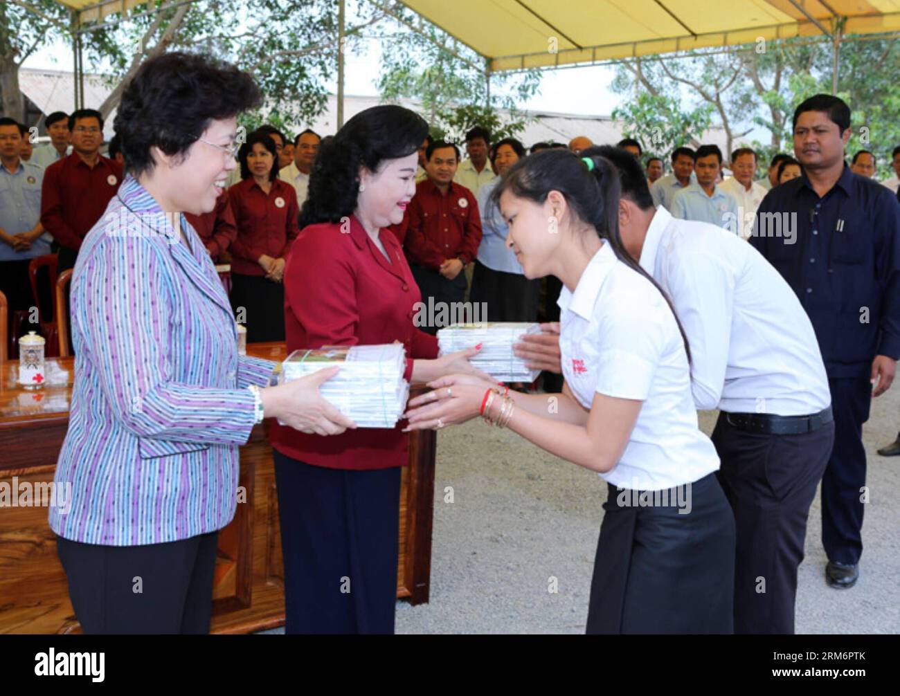 (140125) -- KEP, 25 janv. 2014 (Xinhua) -- le président de la Croix-Rouge cambodgienne Bun Rany (2e L), l'épouse du Premier ministre Hun Sen et l'ambassadeur de Chine au Cambodge BU Jianguo (1e L) font don de livres à des étudiants de la province de Kep, Cambodge, 25 janvier 2014. Samedi, la Croix-Rouge cambodgienne a continué de fournir des articles de secours donnés par la Chine à quelque 1 820 familles victimes des inondations, malades du VIH/SIDA et personnes âgées et handicapées. (Xinhua/Sovannara)(zhf) CAMBODIA-KEP-CHINA-AID PUBLICATIONxNOTxINxCHN Kep Jan 25 2014 XINHUA le président de la Croix-Rouge cambodgienne Bun Rany 2nd l l'épouse des premiers ministres HUN Banque D'Images