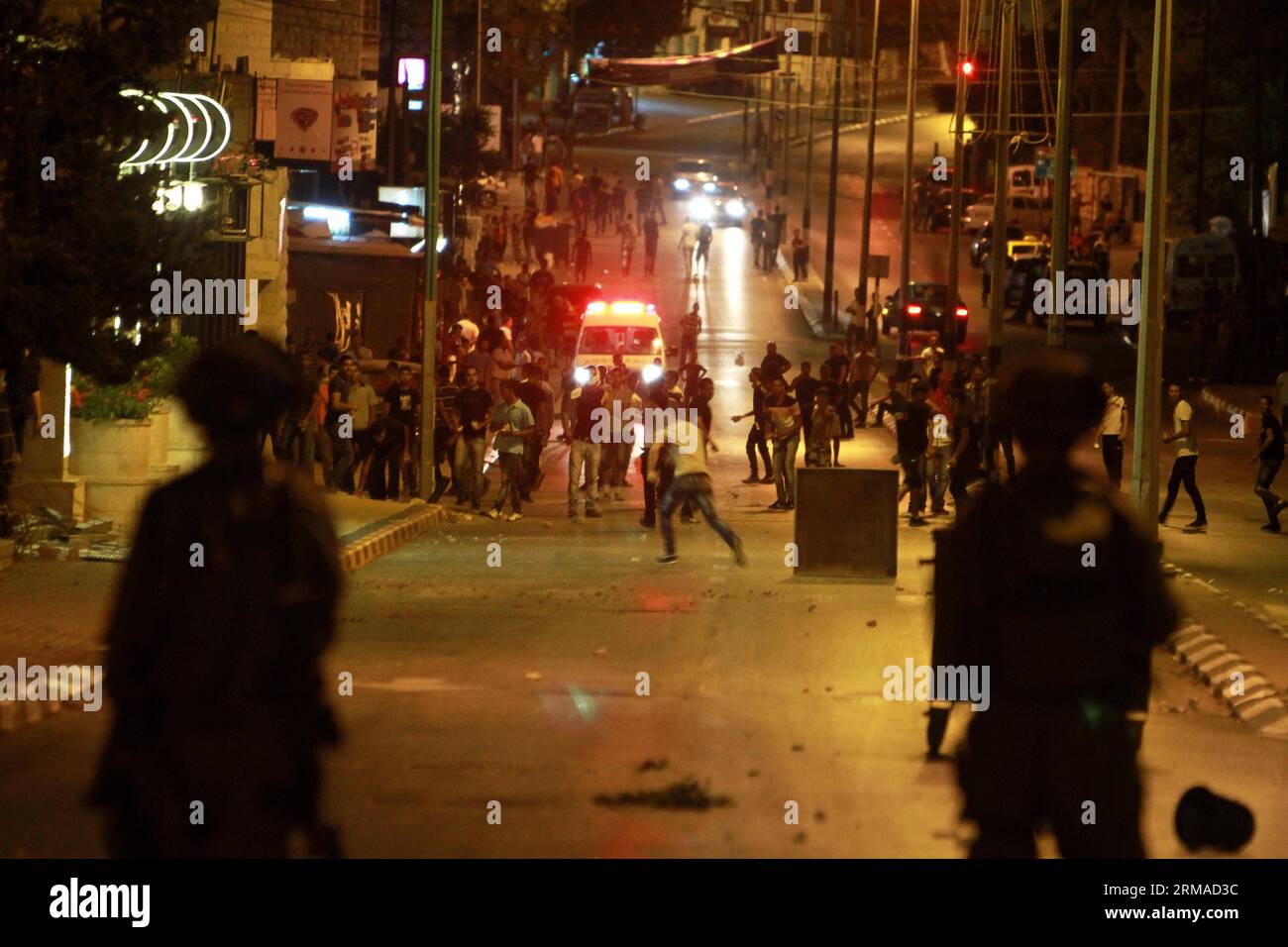 (140703) -- BETHLÉEM, 2 juillet 2014 (Xinhua) -- des manifestants palestiniens jettent des pierres sur des soldats israéliens lors d'affrontements près de la tombe de Rachel dans la ville de Bethléem en Cisjordanie, le 2 juillet 2014. La découverte d’un corps dans une forêt de Jérusalem mercredi a fait naître des soupçons qu’un jeune palestinien disparu avait été tué par des Israéliens vengeant la mort de trois juifs enlevés. Des Palestiniens jetant des pierres se sont affrontés aux forces israéliennes à Jérusalem et en Cisjordanie après la nouvelle, mais aucun blessé grave n'a été signalé. (Xinhua/Luay Sababa) MIDEAST-BETHLEHEM-MILITARY PUBLICATIONxNOTxINxCHN Bethlehem Banque D'Images