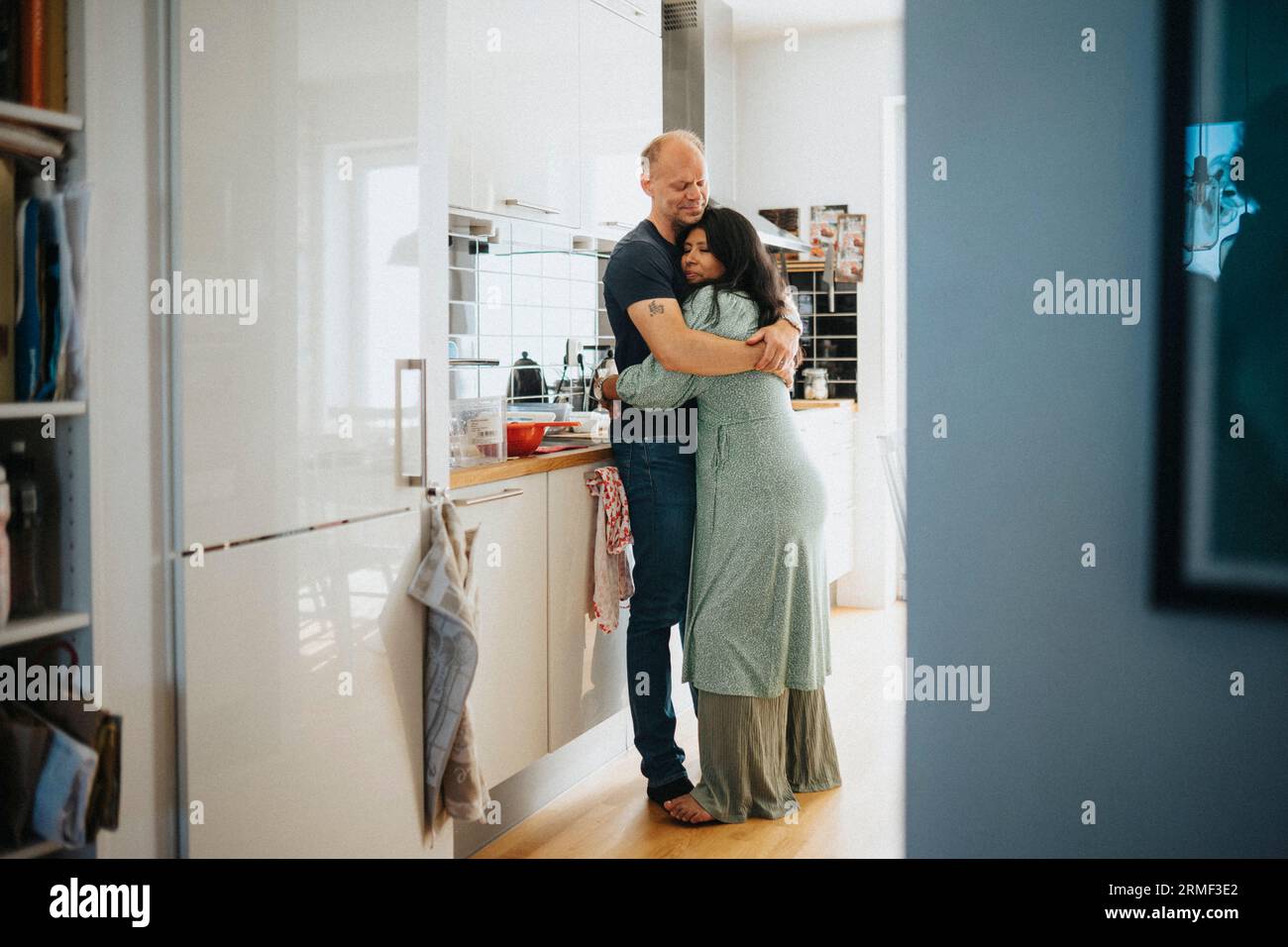 Loving couple hugging in kitchen Banque D'Images