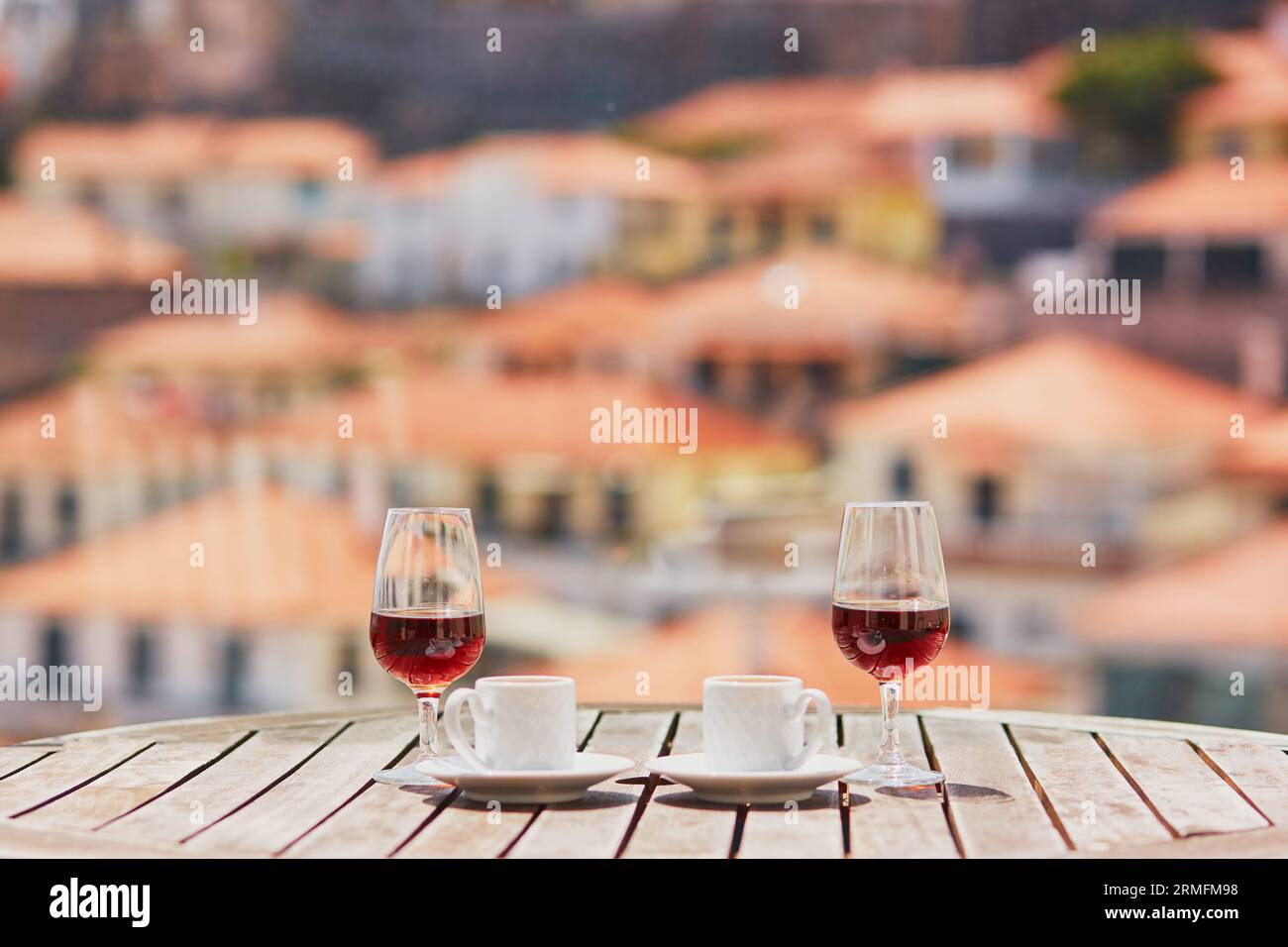 Deux verres de vin de Madère et deux tasses de café expresso frais dans le café de rue avec vue sur la ville de Funchal, Madère, Portugal Banque D'Images