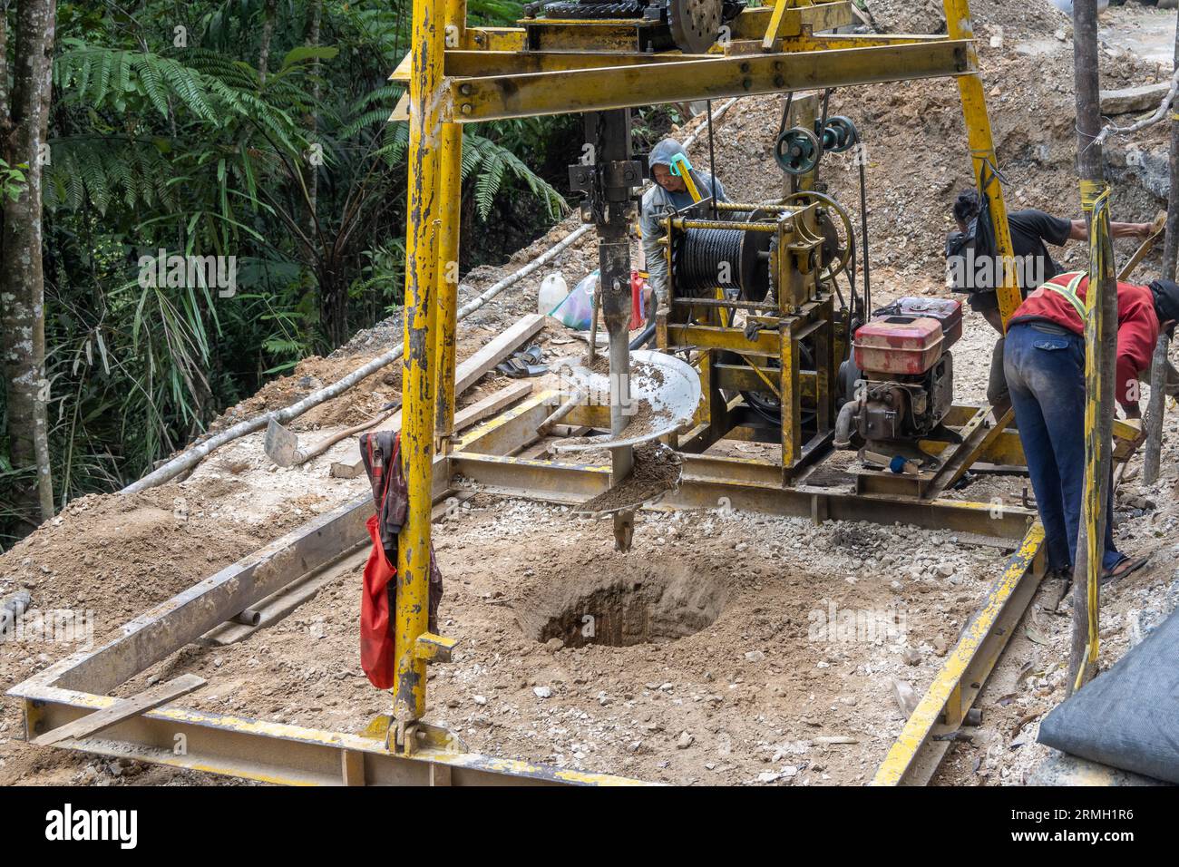 L'équipe routière utilise un foret augur pour forer des trous et stabiliser la pente de la montagne. Sumatra, Indonésie. Banque D'Images L'équipe routière utilise un foret augur pour forer des trous et stabiliser la pente de la montagne. Sumatra, Indonésie. Banque D'Images