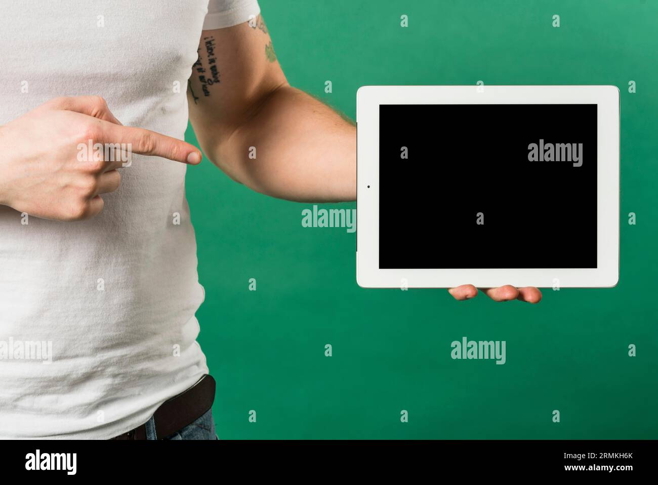 Gros plan de l'homme pointant son doigt vers la tablette numérique avec écran noir Banque D'Images