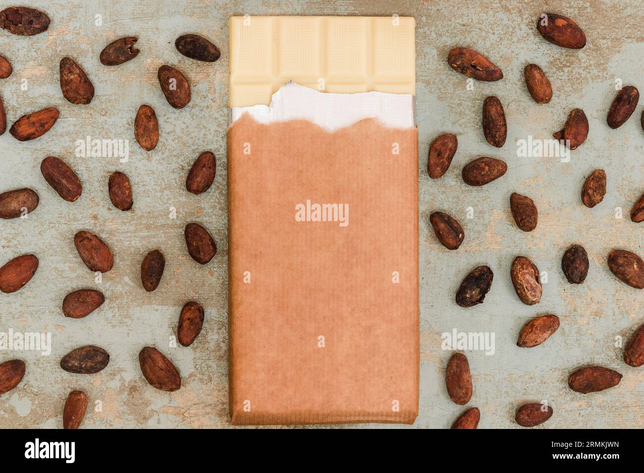 Fèves de cacao dispersées avec fond grunge de barre de chocolat blanc Banque D'Images