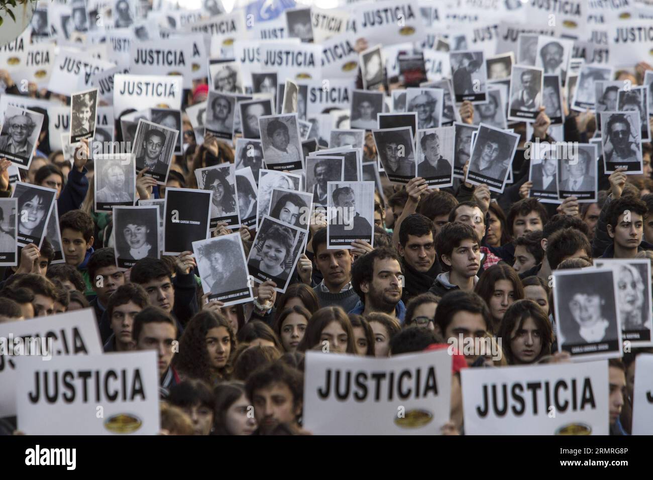 Les résidents tiennent des portraits de victimes lors d’un rassemblement pour commémorer le 20e anniversaire de l’attaque terroriste contre l’Association mutuelle israélite Argentine (AMIA, pour son acronyme en espagnol), à Buenos Aires, capitale de l’Argentine, le 18 juillet 2014. La commémoration a commencé à 9:53 heures du matin, exactement au même moment que l'explosion à l'entrée du bâtiment de l'AMIA s'est produite le 18 juillet 1994, faisant 85 morts et plus de 300 blessés. (Xinhua/Martin Zabala) (vf) (fnc) ARGENTINA-BUENOS AIRES-SOCIETY-ANNIVERSARY PUBLICATIONxNOTxINxCHN Banque D'Images