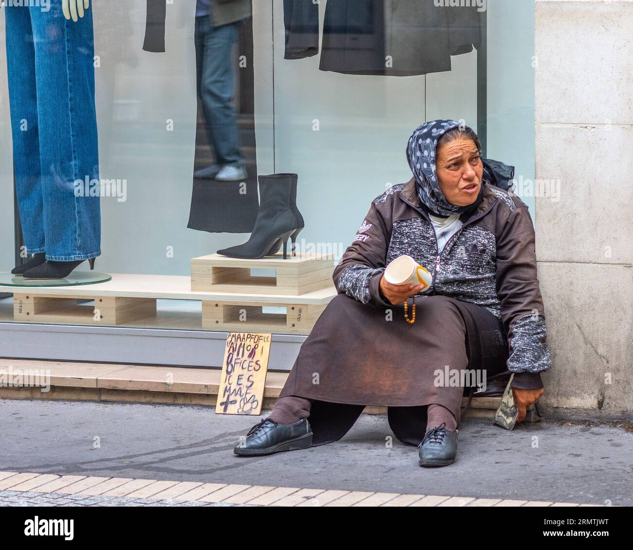 Femme sans abri mendiant de l'argent dans la rue de la ville - Tours, Indre-et-Loire (37), France. Banque D'Images