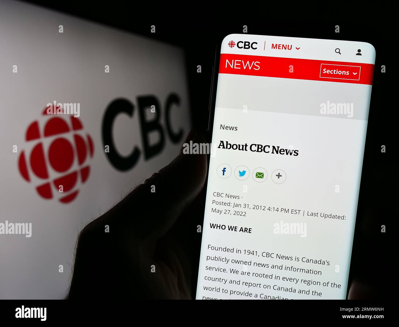 Personne tenant un téléphone intelligent avec la page Web de la Société radio-Canada (SRC) à l'écran devant le logo. Concentrez-vous sur le centre de l'écran du téléphone. Banque D'Images Personne tenant un téléphone intelligent avec la page Web de la Société radio-Canada (SRC) à l'écran devant le logo. Concentrez-vous sur le centre de l'écran du téléphone. Banque D'Images