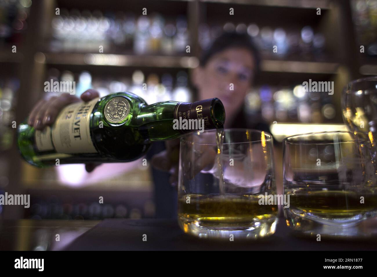 Veronica Tomaghelli, ambassadrice institutionnelle du club de whisky Whisky malt Argentina , sert un whisky au Musée du whisky de Buenos Aires, capitale de l'Argentine, le 4 décembre 2014. Le Musée du Whisky a été ouvert le 10 novembre et montre plus de trois mille bouteilles des meilleurs whiskies du monde. Outre la collection exposée en permanence, le musée comprend des salles de restauration et des salles thématiques où les activités pour les membres du club Whisky malt Argentina sont organisées, apportant une nouvelle attraction touristique et culturelle à la ville de Buenos Aires. Martin Zabala) (azp) ARGENTINE-BUE Banque D'Images