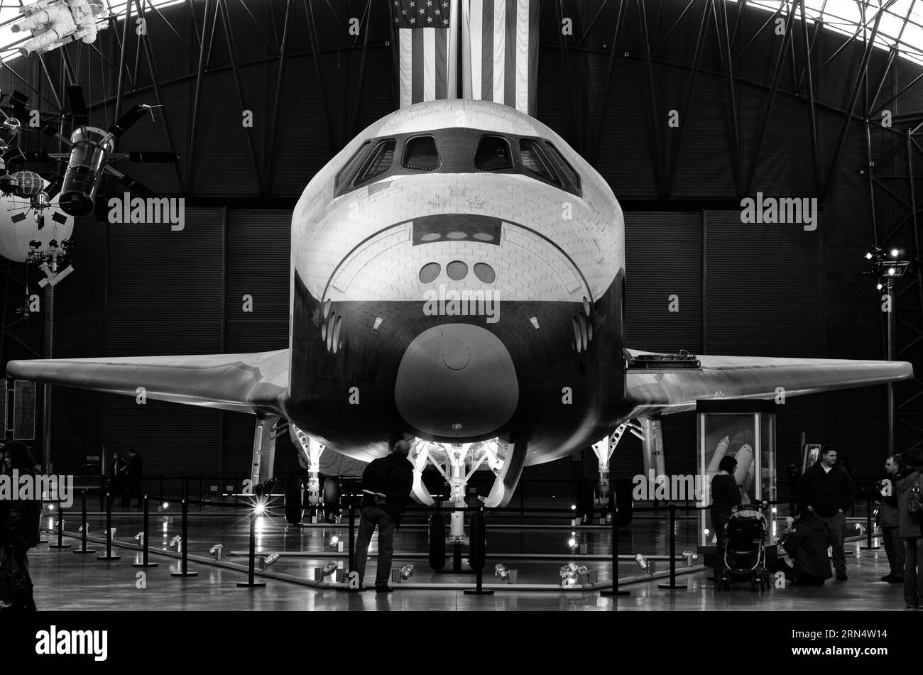 Navette spatiale Enterprise, Steven F. Udvar-Hazy Center, Chantilly. Photographie en noir et blanc montrant une vue frontale du vaisseau spatial avec le drapeau américain en arrière-plan. Banque D'Images