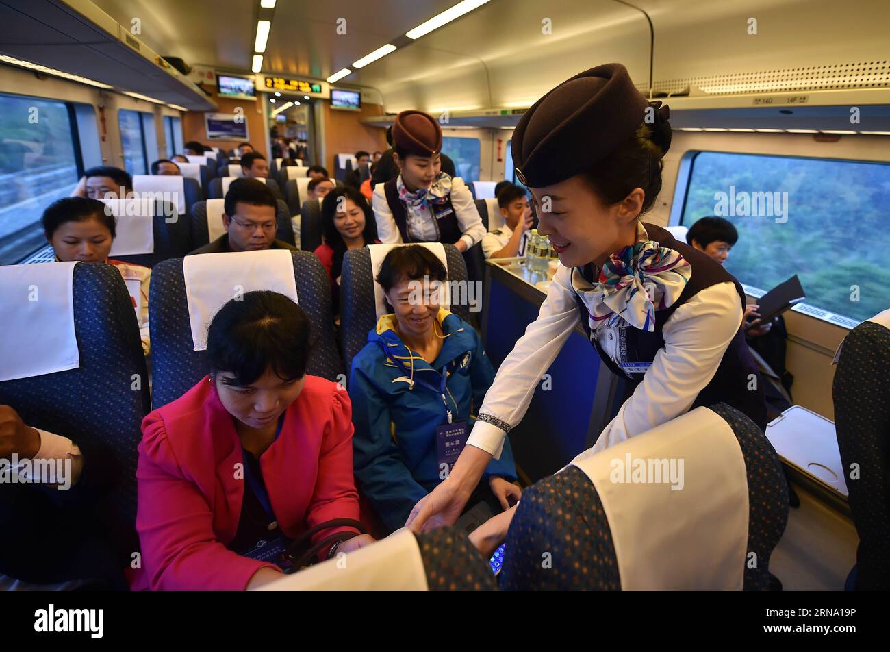 (151230) -- HAIKOU, 30 décembre 2015 -- Steward expédie des boissons et des fruits aux passagers à bord d'un train qui exploite le nouveau train à grande vitesse à Haikou, capitale de la province de Hainan du sud de la Chine, 30 décembre 2015. Le Western Ring Railway de 345 km à Hainan a été mis en service mercredi, achevant la première ligne de train à grande vitesse au monde entourant une île. Le tronçon ouest, avec une vitesse prévue de 200 km/h, compte 16 arrêts dans six villes et comtés, reliant la capitale provinciale Haikou à Sanya, un lieu touristique tropical. (Zwx) CHINE-HAINAN-CHEMIN DE FER À GRANDE VITESSE (CN) GuoxCheng PUBLICATIONxNOTxINxCH Banque D'Images