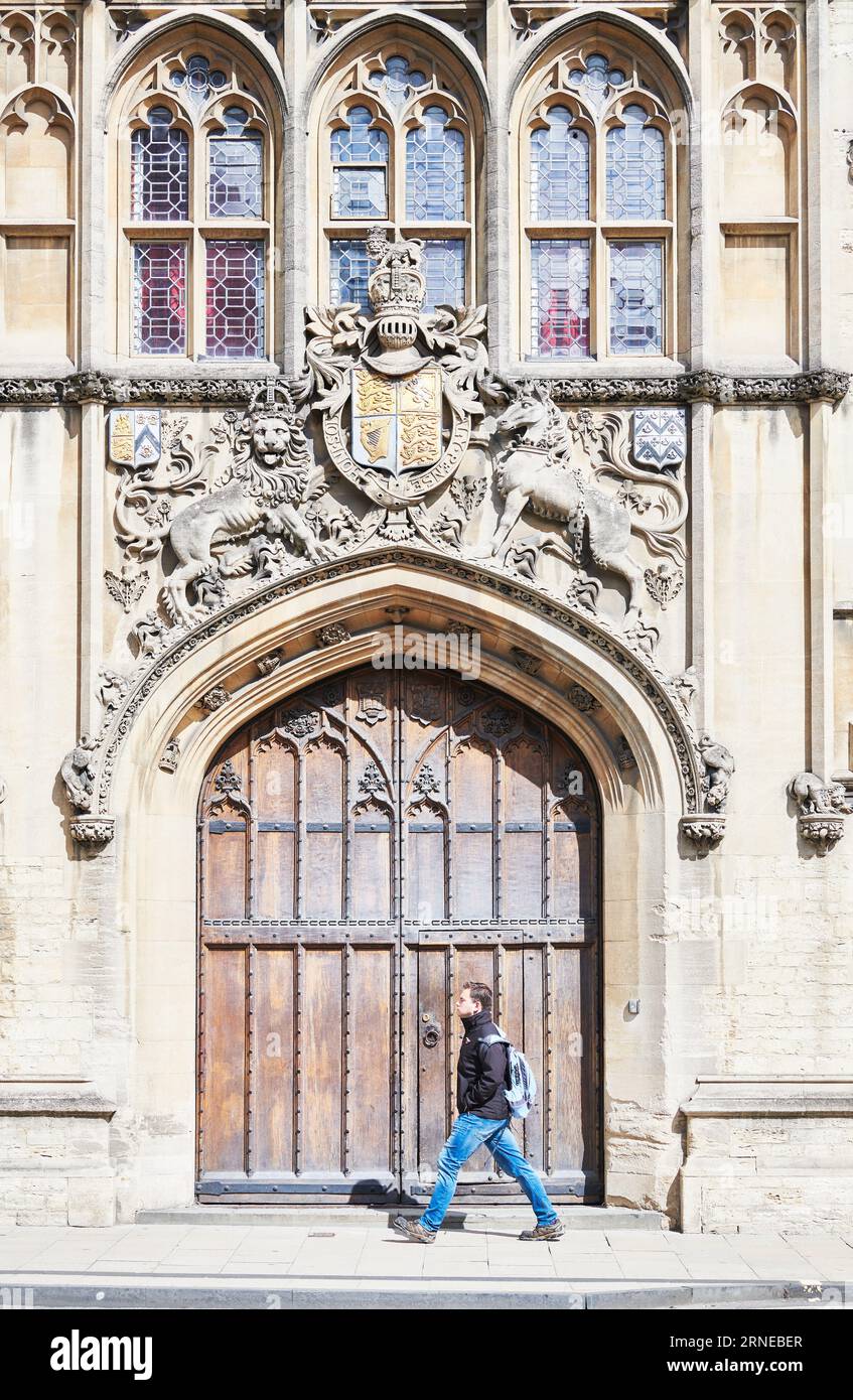 Un étudiant de sexe masculin passe devant une entrée du King's Hall et du College of Brasenose, Université d'Oxford, Angleterre, datant du 13e siècle. Banque D'Images
