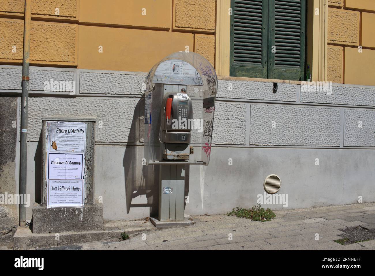 Un vieux téléphone public fonctionne avec des pièces de monnaie et des cartes téléphoniques dans les rues du centre historique. D'ici la fin de 2023, le TIM italien les supprimera. Banque D'Images