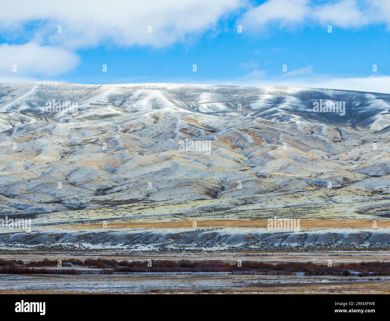 Conduite dans la neige et la glace sur la route panoramique Interstate 15 dans le sud-ouest du Montana à la fin octobre, avec les montagnes enneigées de Pioneer. Banque D'Images