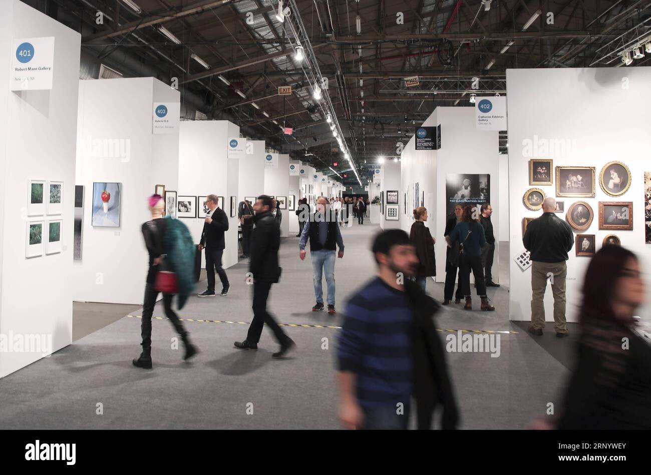(180405) -- NEW YORK, 5 avril 2018 -- les visiteurs regardent des œuvres photographiques au salon de photographie de l'AIPAD (Association of International Photography Art Dealers) à New York, aux États-Unis, le 5 avril 2018. La 38e édition du salon de la photographie se tient du 5 au 8 avril. Environ 100 des plus grandes galeries de photographie artistique au monde présentent une gamme de travaux de qualité muséale, y compris des photographies contemporaines, modernes et du 19e siècle, ainsi que de l'art photographique, de la vidéo et des nouveaux médias. U.S.-NEW YORK-AIPAD-LE SPECTACLE DE PHOTOGRAPHIE WANGXYING PUBLICATIONXNOTXINXCHN Banque D'Images