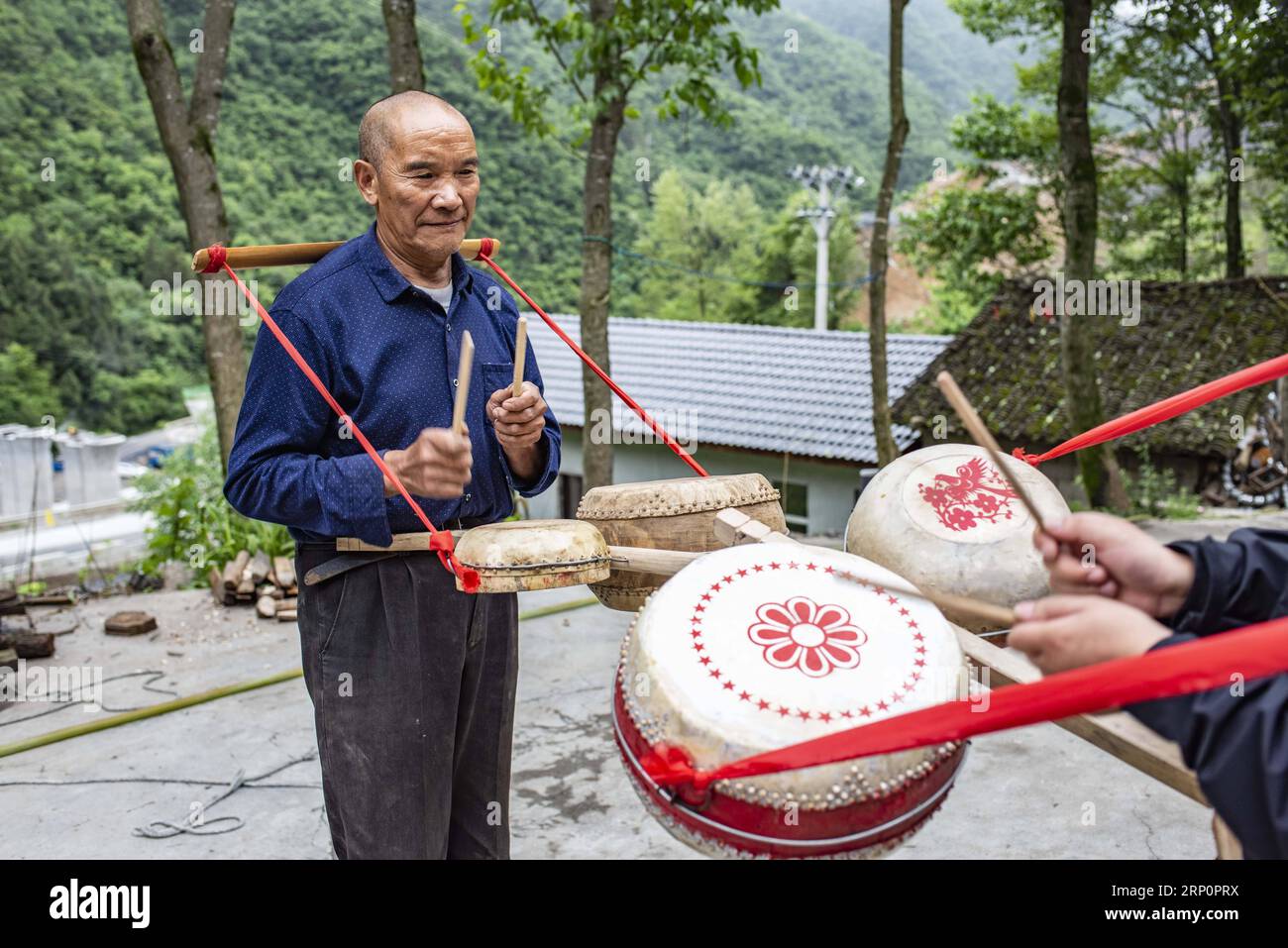 (180522) -- SHENNONGJIA, 22 mai 2018 -- Wu Kaixue montre comment battre le tambour Dingtang dans sa cour dans le village de Longtan, Shennongjia dans la province du Hubei en Chine centrale, le 21 mai 2018. Wu Kaixue, qui a 75 ans, a commencé à apprendre la fabrication des tambours Dingtang quand il avait 13 ans. La fabrication des tambours de Dingtang nécessite des ressources naturelles de la forêt de Shennongjia et nécessite également des techniques de haut niveau. Wu fait plus de 100 tambours en un an et sa renommée s'est répandue loin.) (Zwx) CHINA-HUBEI-DINGTANG TAMBOURS (CN) DuxHuaju PUBLICATIONxNOTxINxCHN Banque D'Images