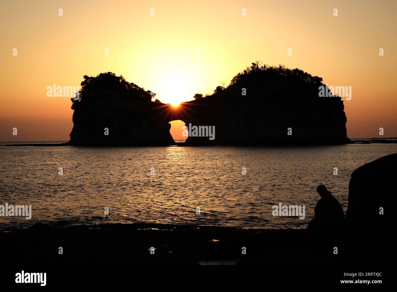 (190213) -- WAKAYAMA, 13 février 2019 (Xinhua) -- la photo prise le 13 février 2019 montre l'île Engetsu sous le coucher du soleil à Wakayama, Japon. Engetsu Island est une petite île avec une arche naturelle au large de la côte de Shirahama dans la préfecture de Wakayama au Japon. (Xinhua/du Xiaoyi) JAPON-ÎLE WAKAYAMA-ENGETSU-COUCHER DE SOLEIL PUBLICATIONxNOTxINxCHN Banque D'Images