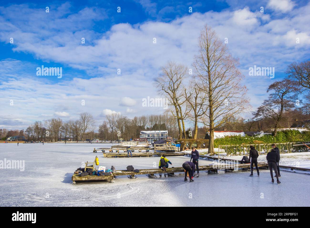 Bord du lac avec des jetées et des gens se préparent à patiner sur le lac Paterswoldse Meer à Groningen, pays-Bas Banque D'Images