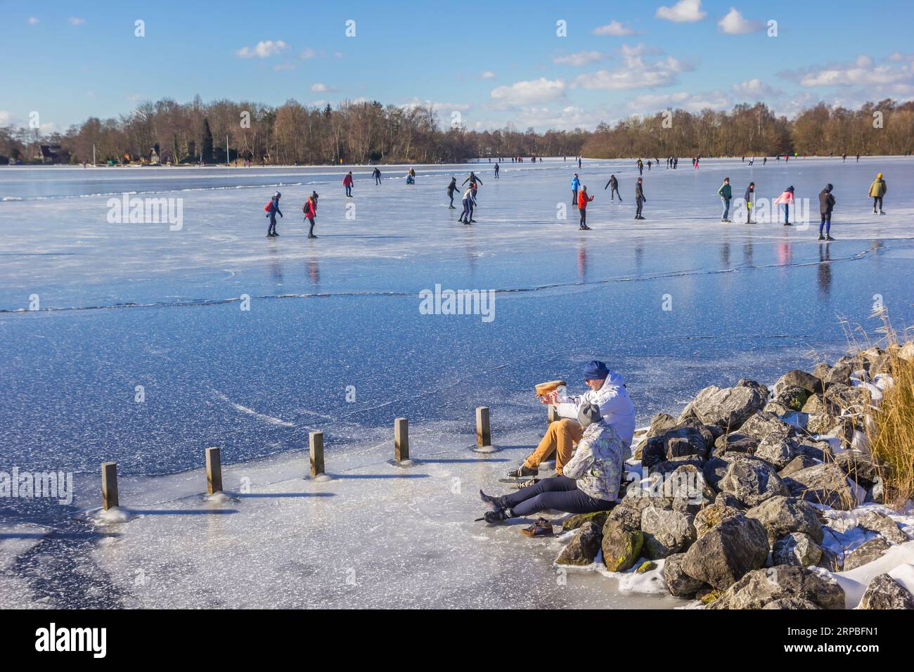 Les gens mettant leurs patins au bord du lac Paterswolde à Groningen, pays-Bas Banque D'Images