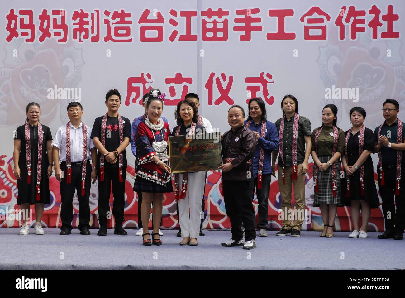 (190823) -- DANZHAI, 23 août 2019 -- les invités confèrent la plaque lors de la cérémonie de création d'une coopérative artisanale Miao dans le comté de Taijiang, province du Guizhou au sud-ouest de la Chine, le 22 août 2019. Une coopérative artisanale et une coopérative artisanale batik de MOM Handworks , un projet de bien-être public initié par la Fondation chinoise pour le développement des femmes (CWDF), ont été mises en service à Taijiang et Danzhai, respectivement. Le débarquement de deux coopératives explore un nouveau mode de réduction de la pauvreté, combinant les gouvernements locaux, les organisations à but non lucratif et les institutions culturelles ensemble au sein du deve Banque D'Images