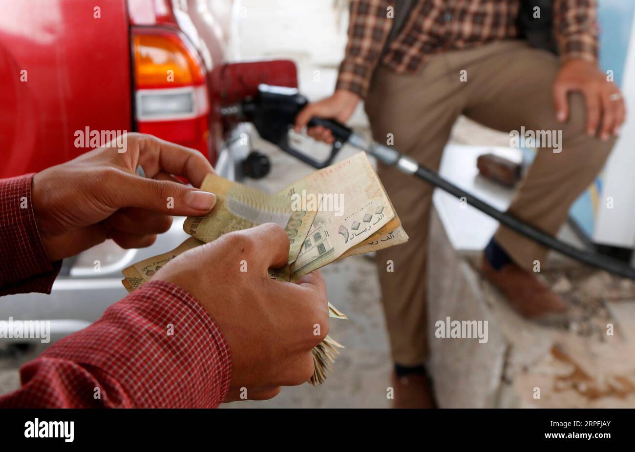 190925 -- SANAA, 25 septembre 2019 -- Un homme compte de l'argent à payer après avoir fait le plein de sa voiture à Sanaa, Yémen, le 25 septembre 2019. Le Yémen est confronté à une pénurie de carburant depuis quelques jours. Photo Mohammed Mohammed/Xinhua YÉMEN-SANAA-PÉNURIE DE CARBURANT nieyunpeng PUBLICATIONxNOTxINxCHN Banque D'Images