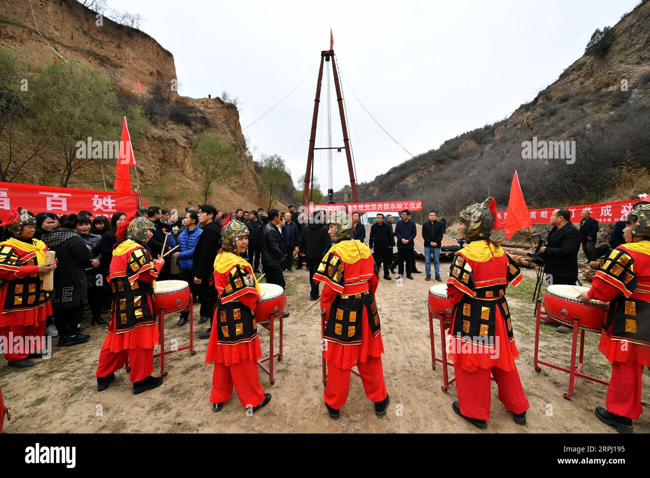 191122 -- COMTÉ DE YICHENG, le 22 novembre 2019 -- des villageois assistent à une cérémonie d'achèvement pour le forage d'un puits en eau profonde dans le village de Nanling du comté de Yicheng, province du Shanxi, au nord de la Chine, le 20 novembre 2019. Lorsque l'interrupteur a été tiré, l'eau a jailli de 403 mètres plus bas. Le tout premier puits en eau profonde de Nanling Village a été mis en service un matin tôt d hiver. Dans le passé, le village, qui s’étendait à travers les ravins des montagnes Zhongtiao dans le nord de la Chine, dépendait uniquement des fosses à boue pour stocker sa précieuse eau potable depuis des siècles. Hantées par la peur de la sécheresse, les générations avaient dr Banque D'Images