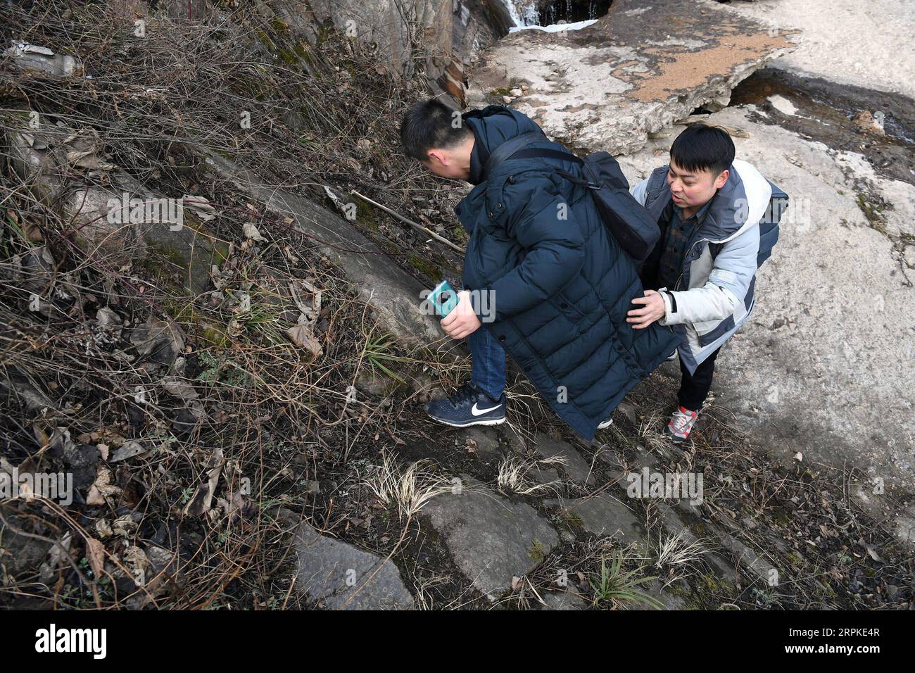 200109 -- BAOJI, le 9 janvier 2020 -- le directeur adjoint de la gare Ma Chi R est sur la route de montagne pour retourner à la gare de Qingshiya avec un collègue au sommet des montagnes Qinling dans la ville de Baoji, province du Shaanxi au nord-ouest de la Chine, le 7 janvier 2020. La gare de Qingshiya est au sommet des montagnes de Qinling sur le premier chemin de fer électrifié de Chine, Baoji - Chengdu Railway. Entourée de falaises abruptes, la station des nuages se compose de seulement deux voies et sert de court arrêt pour les trains qui passent sur le chemin de fer. Aussi petite qu'elle soit, la station possède tous les organes vitaux. Pour garantir le fonctionnement du chemin de fer St Banque D'Images