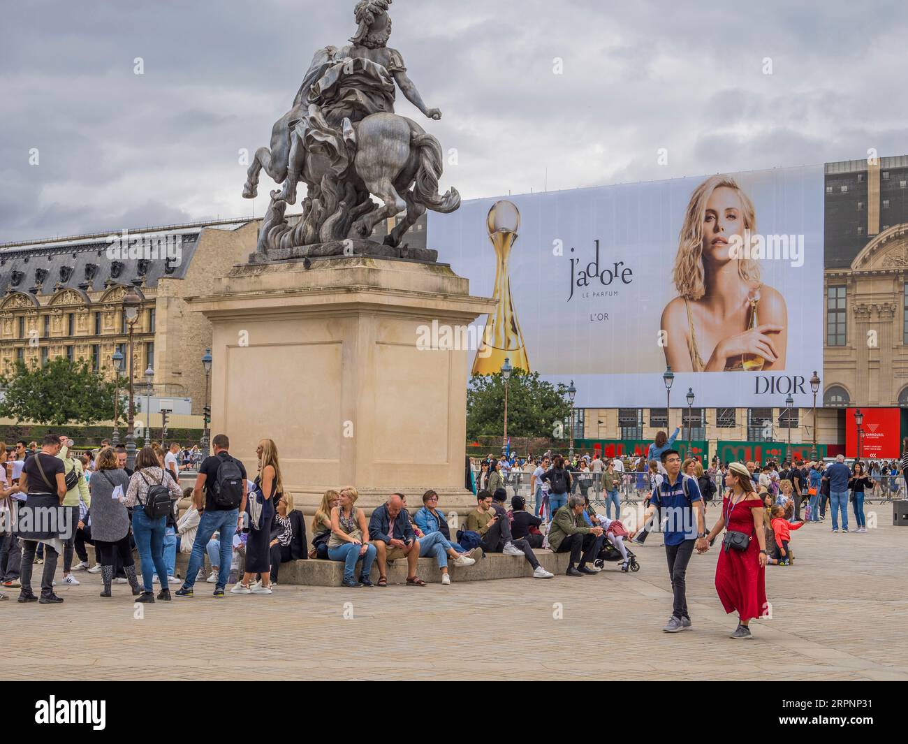Charlize Theron parfum Publicité, touristes dans la cour, Musée du Louvre, Paris, France, Europe, UE. Banque D'Images