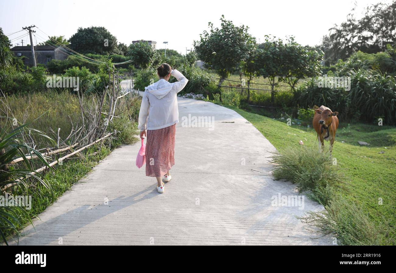 200909 -- GUANGZHOU, le 9 septembre 2020 -- Lin Xiaolian se rend chez un étudiant pour y rendre visite après l'école sur l'île de Beili dans le comté de Xuwen, province du Guangdong, dans le sud de la Chine, le 1 septembre 2020. Il y a six ans, Lin Xiaolian est venu sur cette île en tant que professeur bénévole après avoir obtenu son diplôme de l'Université normale de Lingnan dans le Guangdong. Et puis elle a choisi de rester ici pour être enseignante. Le village insulaire isolé et pauvre de Beili ne voit guère les étrangers. Il n'y a pas de restaurants, d'hôtels ni de voitures sur l'île couvrant seulement 7 kilomètres carrés. L'école primaire Beili a plus de 300 élèves, mais Banque D'Images