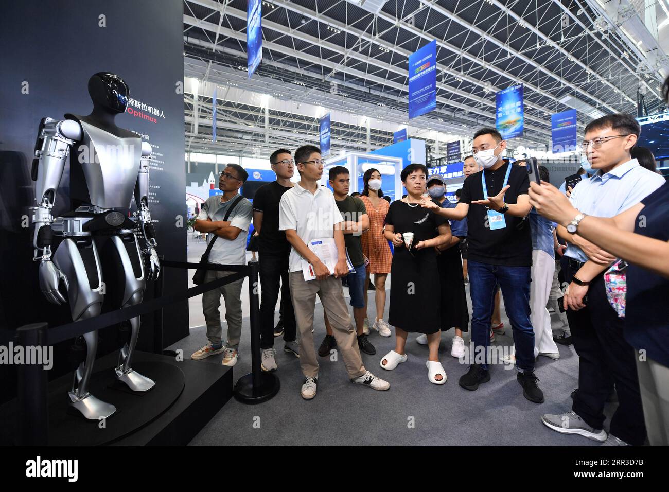 Shijiazhuang, province chinoise du Hebei. 6 septembre 2023. Un membre du personnel explique alors que les visiteurs regardent un robot fabriqué par Tesla lors de la China International Digital Economy Expo 2023 à Shijiazhuang, dans la province du Hebei, dans le nord de la Chine, le 6 septembre 2023. L'exposition internationale de l'économie numérique de la Chine 2023 a débuté ici mercredi, en mettant l'accent sur le développement de l'Internet industriel. Crédit : Luo Xuefeng/Xinhua/Alamy Live News Banque D'Images