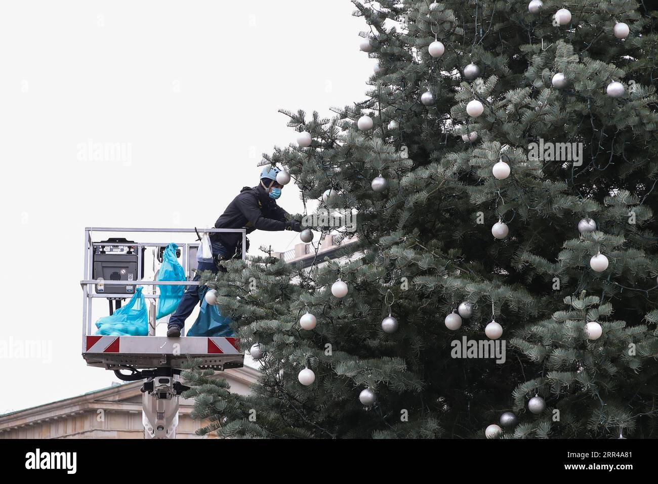 201126 -- BERLIN, le 26 novembre 2020 -- Un ouvrier décore le sapin de Noël devant la porte de Brandebourg à Berlin, capitale de l'Allemagne, le 26 novembre 2020. À la suite de la hausse des taux d’infection par le COVID-19 en Allemagne, les gouvernements fédéral et des États ont décidé le 25 novembre que le confinement partiel, y compris la fermeture des restaurants, des bars, des théâtres et des installations de loisirs, serait prolongé jusqu’au 20 décembre. Photo de Shan Yuqi/Xinhua ALLEMAGNE-BERLIN-COVID-19-EXTENSION PARTIELLE DU CONFINEMENT DanxYuqi PUBLICATIONxNOTxINxCHN Banque D'Images