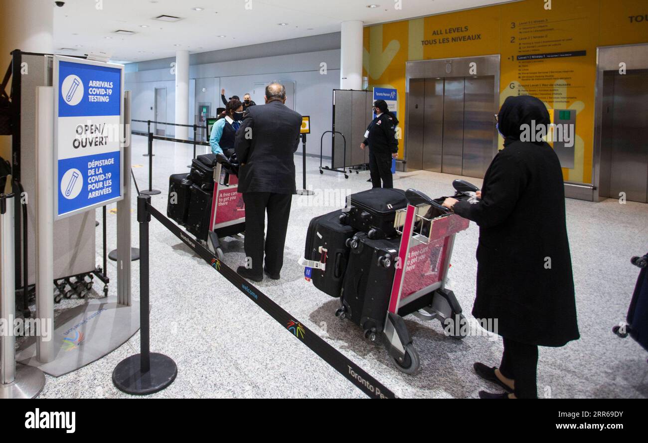 210202 -- TORONTO, le 2 février 2021 -- les voyageurs marchent avec leurs chariots à bagages jusqu'à un site de dépistage de la COVID-19 après être arrivés au hall des arrivées de l'aéroport international de Toronto à Mississauga, Ontario, Canada, le 1 février 2021. Au Canada, l Ontario a exigé que tous les passagers arrivant à l étranger passent un test COVID-19 à leur arrivée à compter du lundi afin d arrêter la propagation des variantes de la COVID-19. Photo de /Xinhua CANADA-ONTARIO-COVID-19-MESURES ZouxZheng PUBLICATIONxNOTxINxCHN Banque D'Images