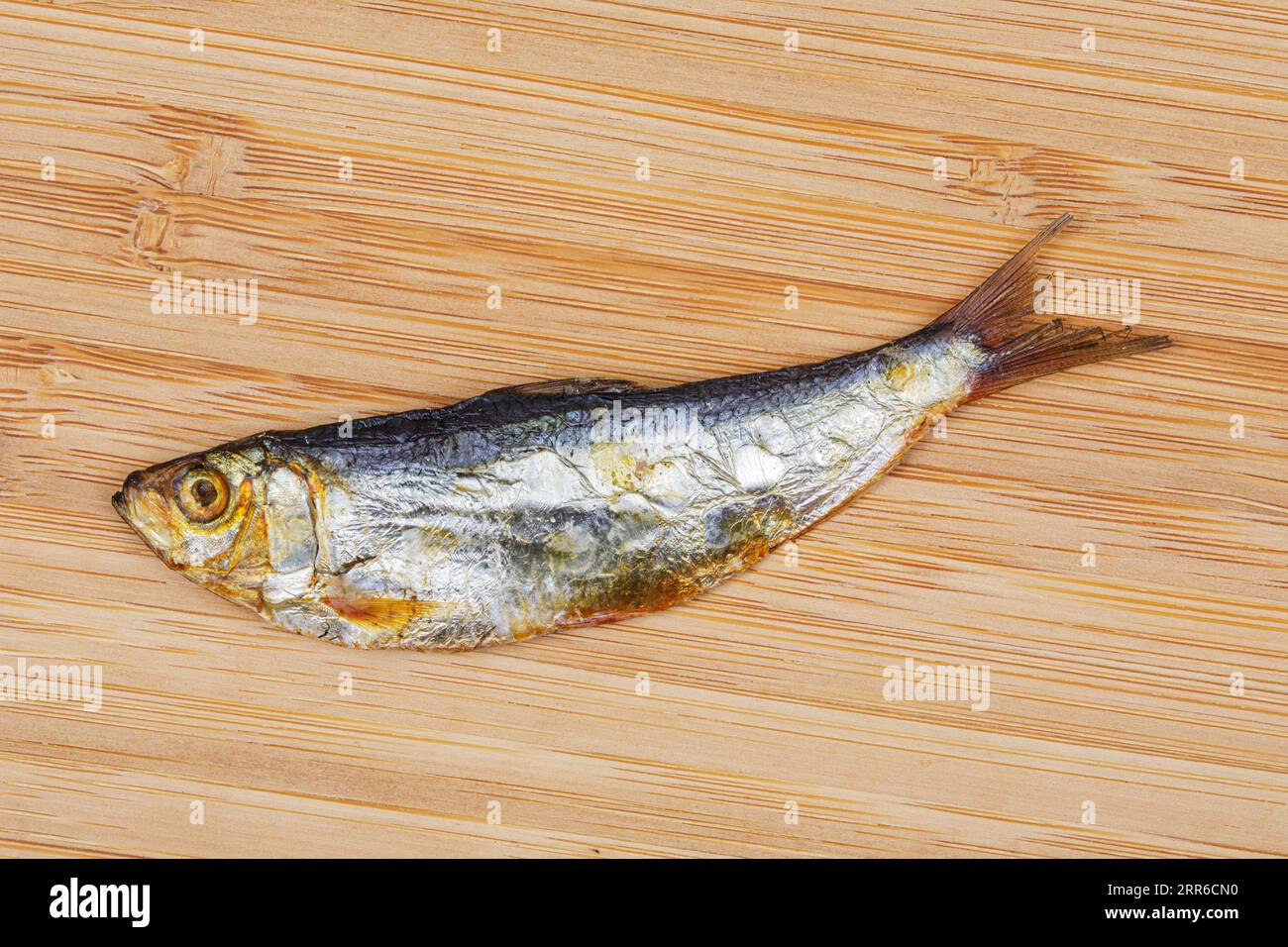 Petit poisson séché isolé sur un fond en bois avec espace copie, considéré comme une épicerie fine dans la plupart des pays asiatiques, Philippines, Asie du Sud-est Banque D'Images
