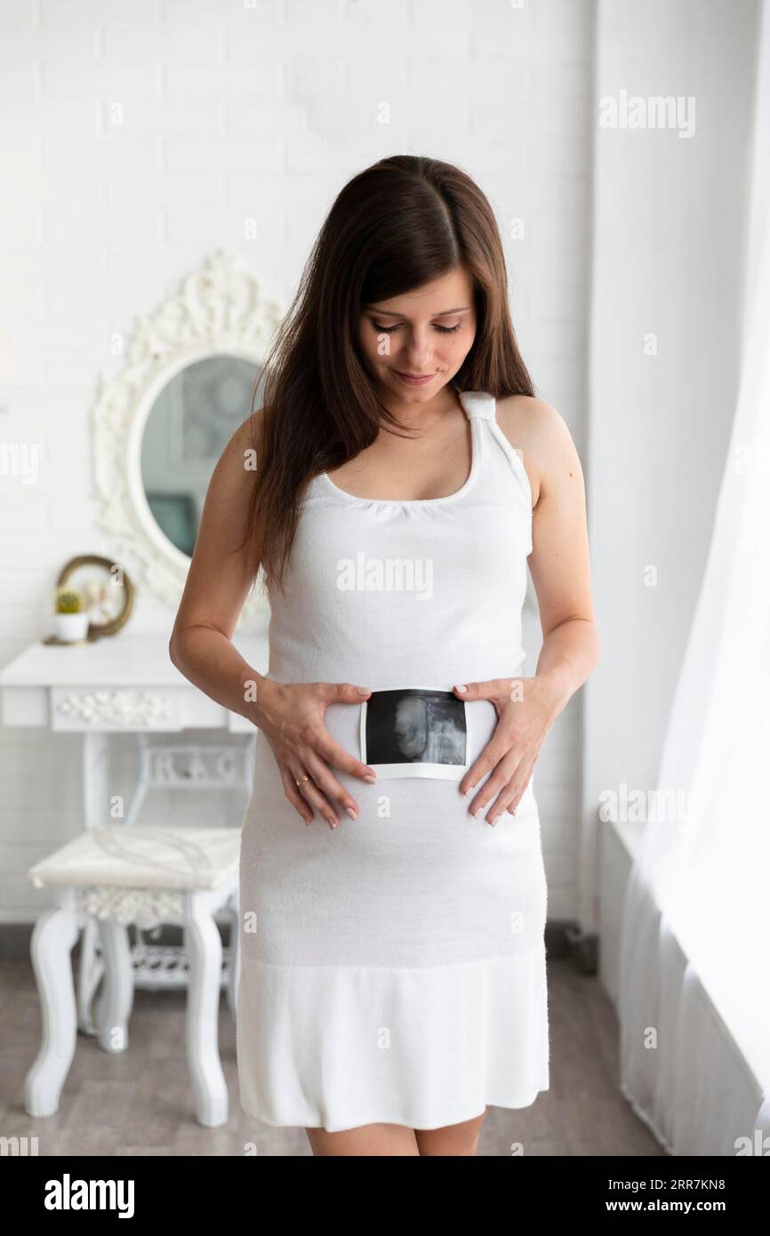 Femme montrant l'échographie de son bébé Banque D'Images