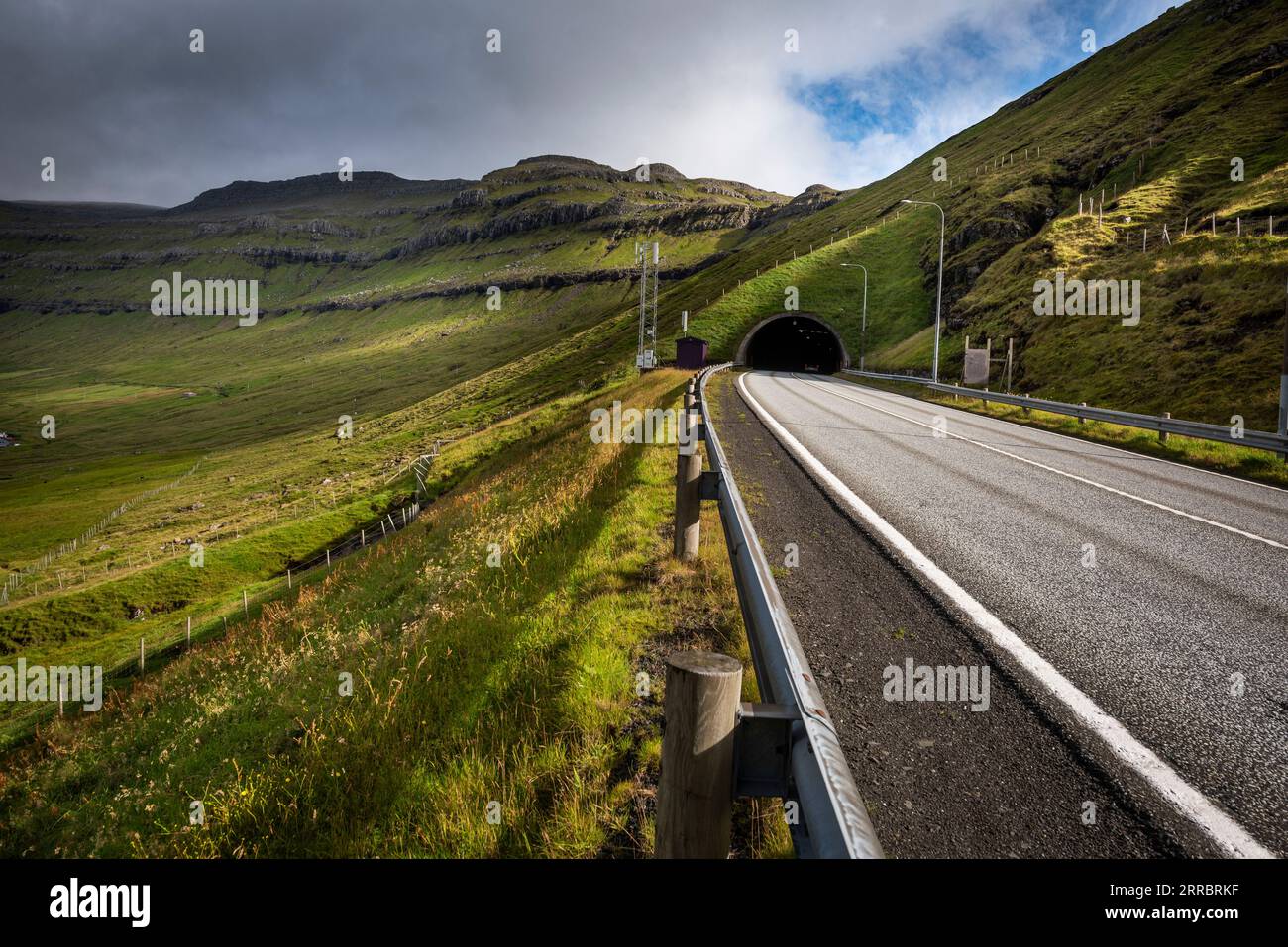 Des traînées de lumière matinale traversent l'autoroute et le tunnel menant de Kollafjør∂ur à la partie sud de l'île Streymoy dans les îles Féroé. Banque D'Images