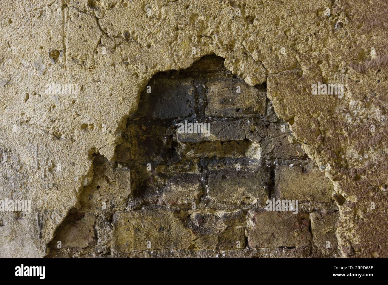 plâtre émiettant sur un vieux mur de briques Banque D'Images