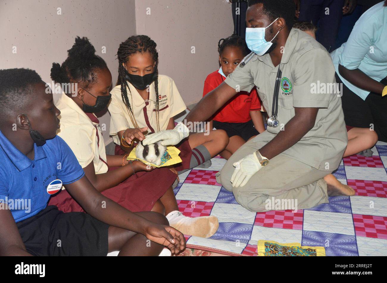 220303 -- ENTEBBE OUGANDA, 3 mars 2022 -- Un vétérinaire spécialiste de la santé montre comment manipuler un lapin lors des célébrations de la Journée mondiale de la vie sauvage au Centre ougandais d'éducation à la conservation de la vie sauvage à Entebbe, Ouganda, le 3 mars 2022. Photo de /Xinhua OUGANDA-ENTEBBE-JOURNÉE MONDIALE DE LA FAUNE NicholasxKajoba PUBLICATIONxNOTxINxCHN Banque D'Images