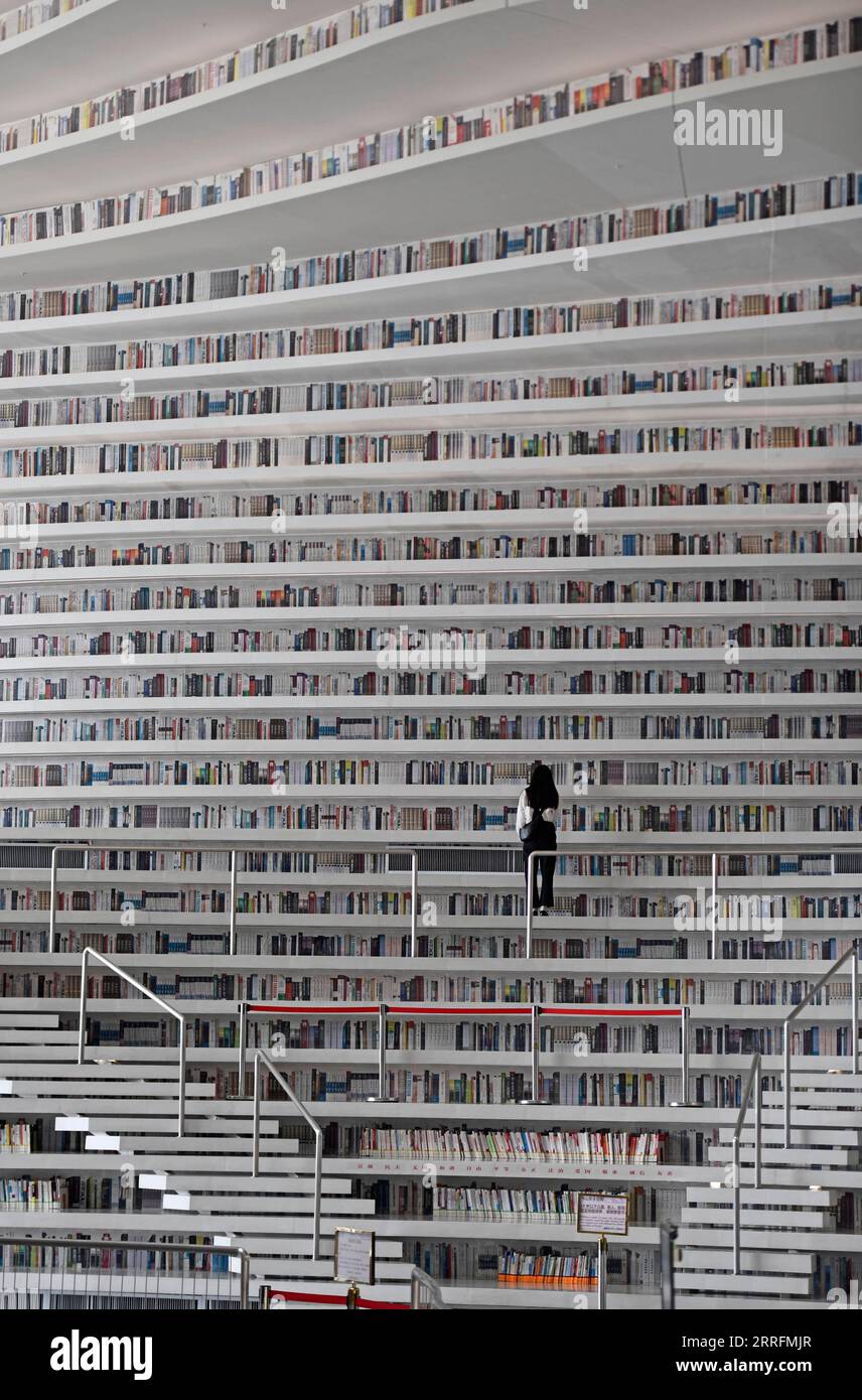 China, neue Bibliothek von Tianjin eröffnet 220421 -- TIANJIN, le 21 avril 2022 -- Un lecteur choisit des livres à la bibliothèque Tianjin Binhai à Tianjin, dans le nord de la Chine, le 20 avril 2022. La bibliothèque, un monument culturel de Tianjin, a été officiellement ouverte au public en octobre 2017. Son design époustouflant a reçu beaucoup d'attention du public. CHINE-TIANJIN-BINHAI NOUVELLE ZONE-BIBLIOTHÈQUE CN ZHAOXZISHUO PUBLICATIONXNOTXINXCHN Banque D'Images