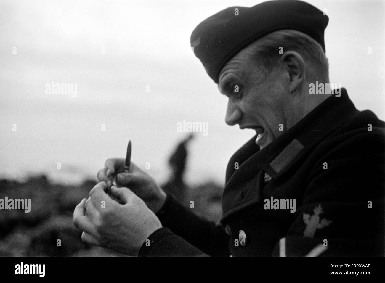 Der Fotograf Erich Andres in der Uniform der Kriegsmarine öffnet Muscheln am Strand von le Havre UM sie zu verzehren, 1940. Le photographe Erich Andres dans son uniforme de Kriegsmarine ouvre des moules sur la plage du Havre pour les manger, 1940. Banque D'Images