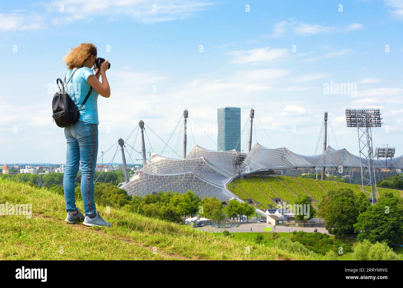 Touriste féminine prend des photos du parc olympique en été, Munich, Allemagne. Cet endroit est célèbre point de repère de la ville de Munchen. Concept de gens de voyage, touri Banque D'Images