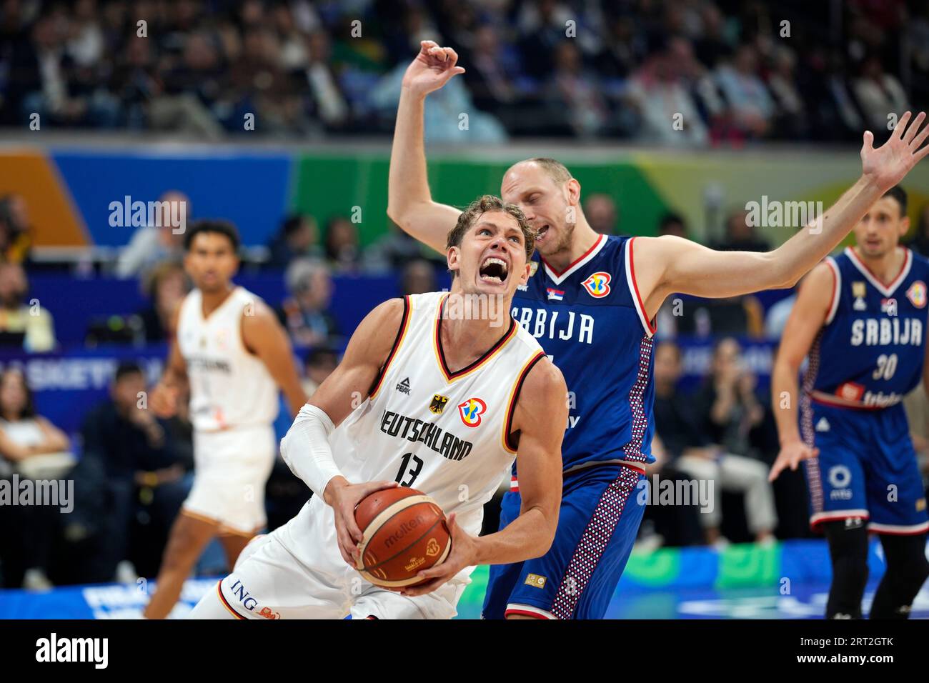Germany forward Moritz Wagner (13) looks to shoot in front of Serbia forward Dejan Davidovac (27) during the championship game of the Basketball World Cup in Manila, Philippines, Sunday, Sept. 10, 2023. (AP Photo/Aaron Favila) Banque D'Images