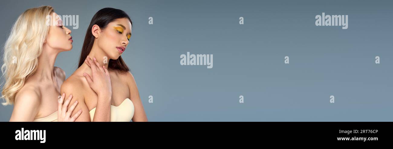divers modèles avec maquillage des yeux audacieux posant ensemble sur fond bleu, concept de tendance de beauté, bannière Banque D'Images