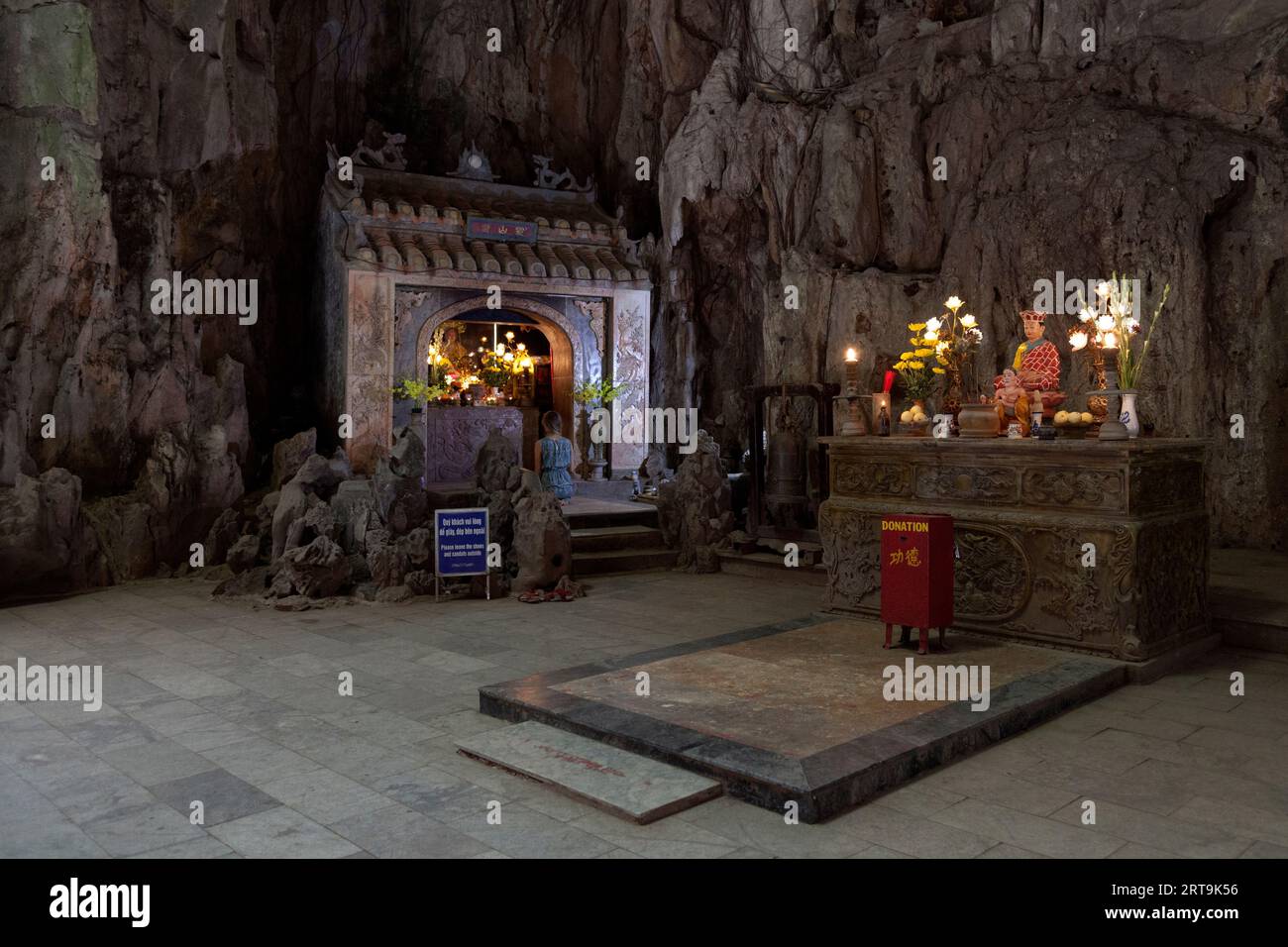 Da Nang, Vietnam - août 21 2018 : Femme priant dans un sanctuaire à l'intérieur de la grotte de Huyen Khong dans les montagnes de marbre, Da Nang. Banque D'Images